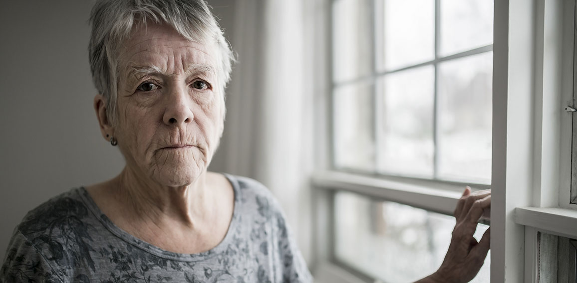 A sad lonely 70 years old senior in is apartment