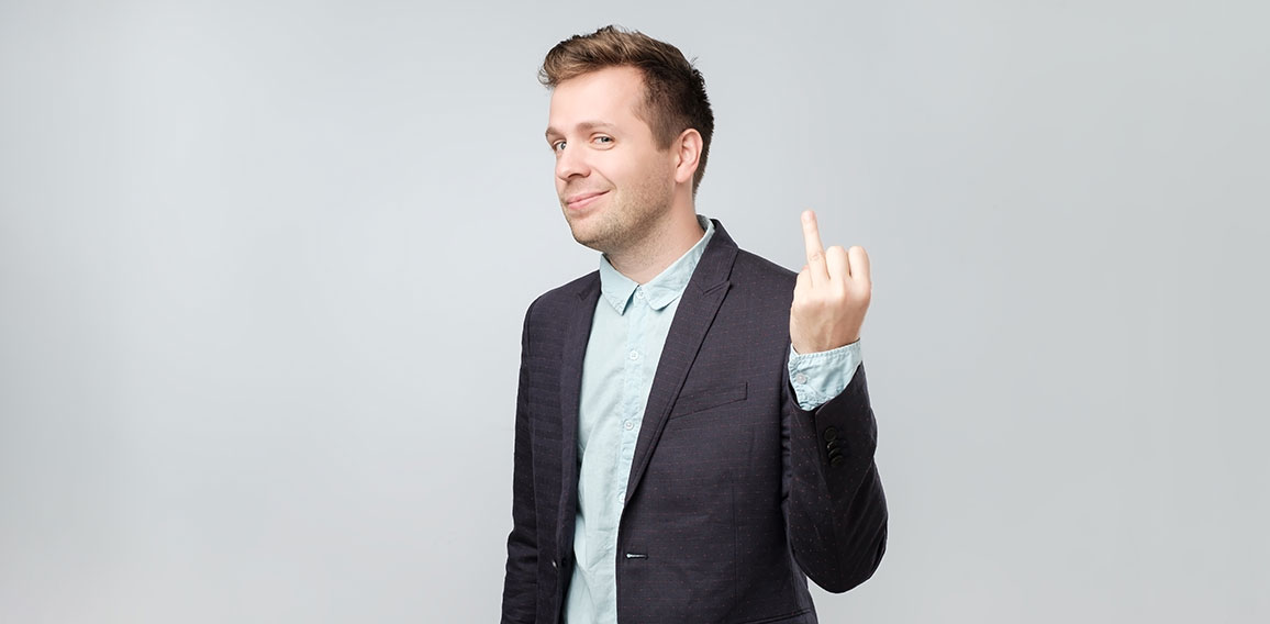 Caucasian man in suit showing his finger without marriage ring. He has divorced and now is very happy to be free