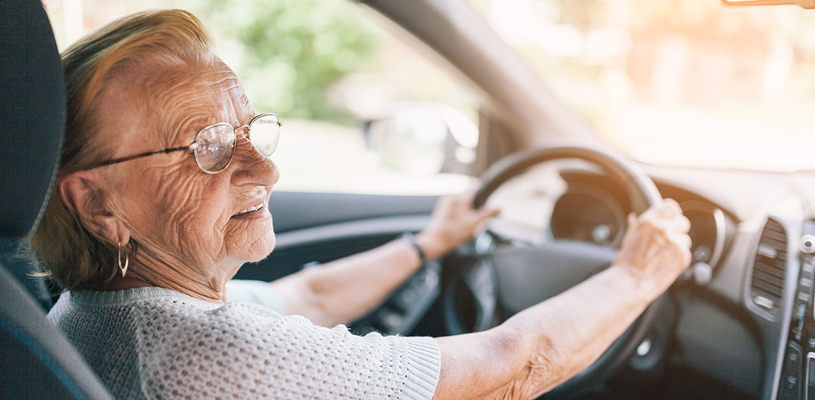 Elderly woman behind the steering wheel