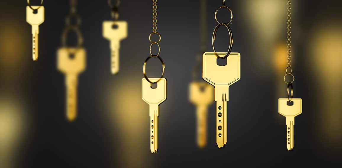 Gold keys on chains, real estate concept