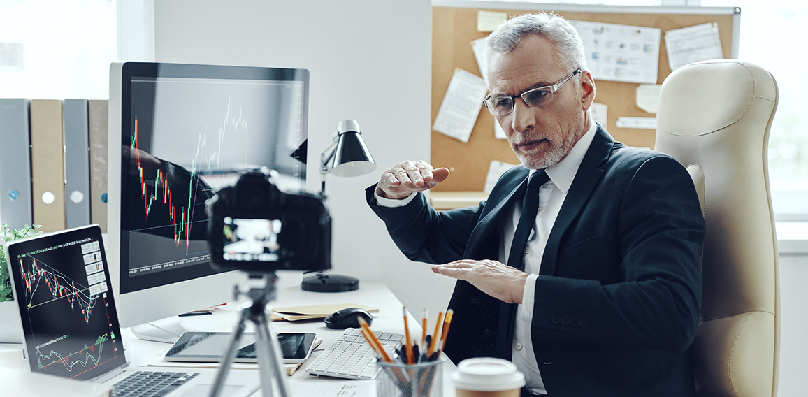 Senior man in elegant business suit using modern technologies wh