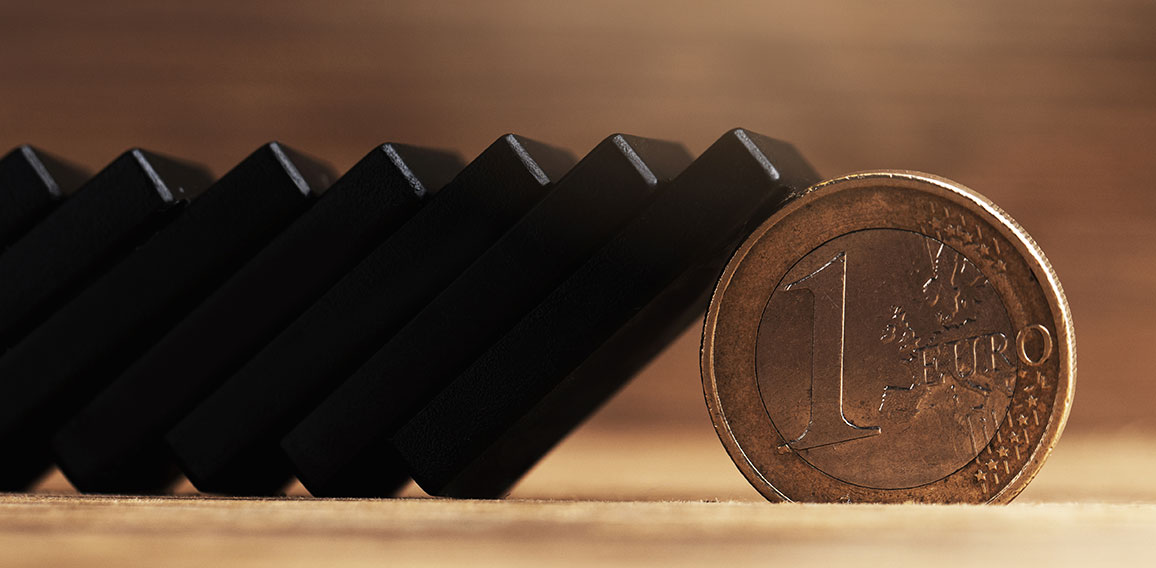 Chain of black domino tiles falling stopped by a one euro coin.