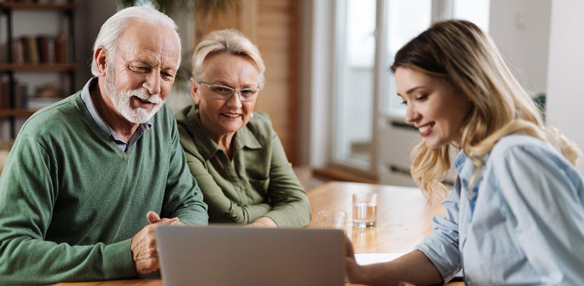 Senior couple talking to insurance agent at home