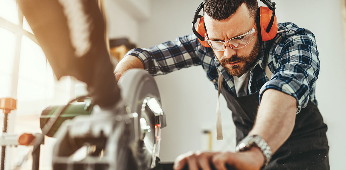 young male carpenter working in  workshop