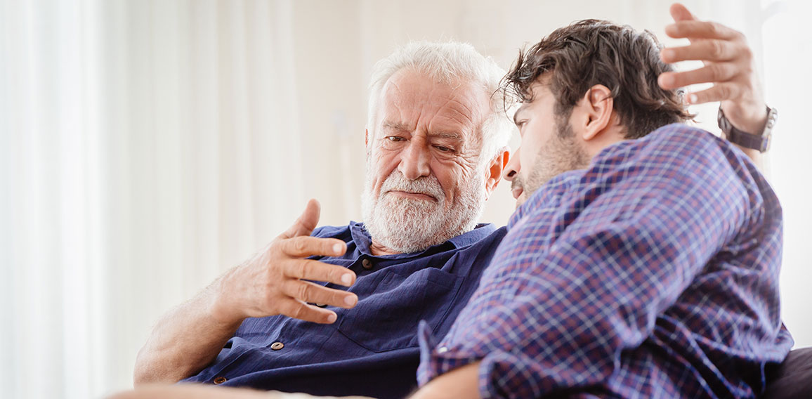 old man serious discussion with younger man indoor, grand father