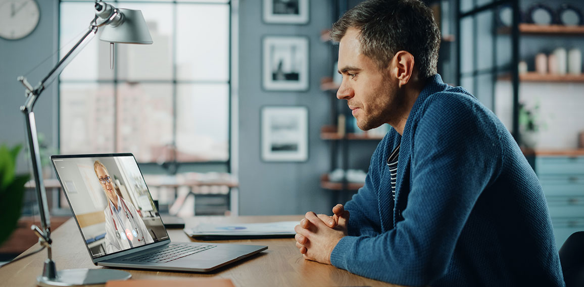 Handsome Caucasian Man Having a Video Call with Female Doctor on