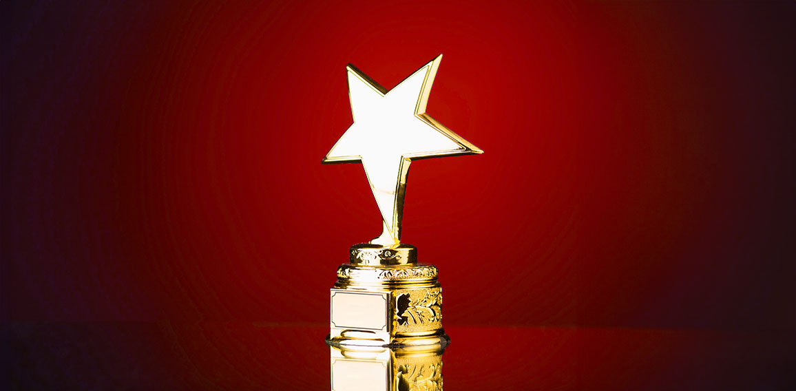 gold star trophy against blue background