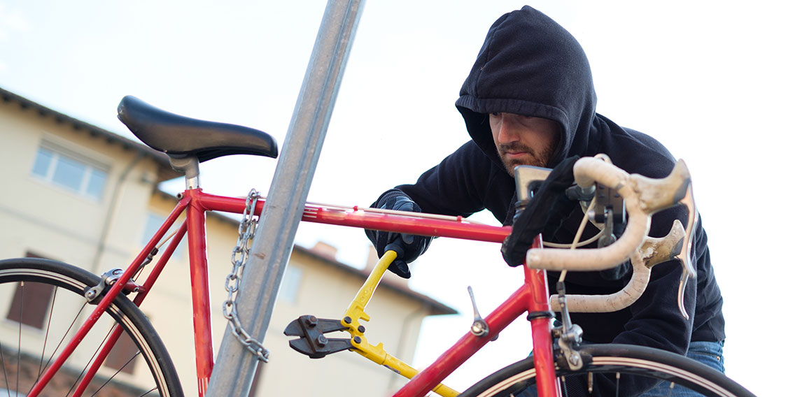 Thief stealing a bike in the city street