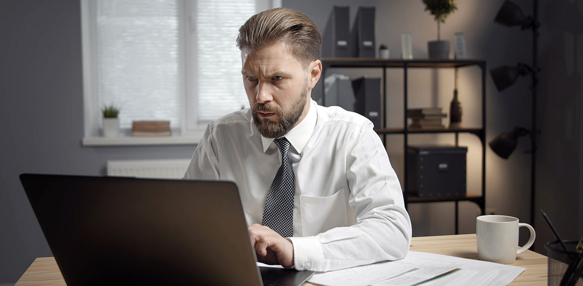 Concentrated businessman working on laptop