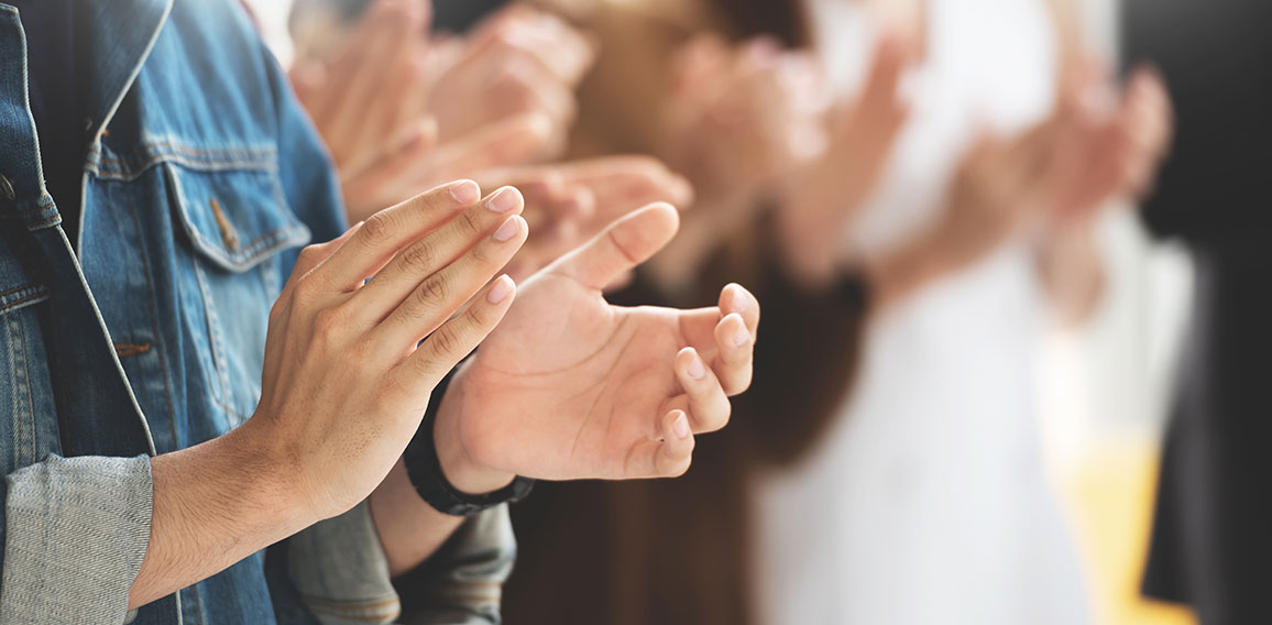 Cropped image of Creative designers audience applauding at a bus