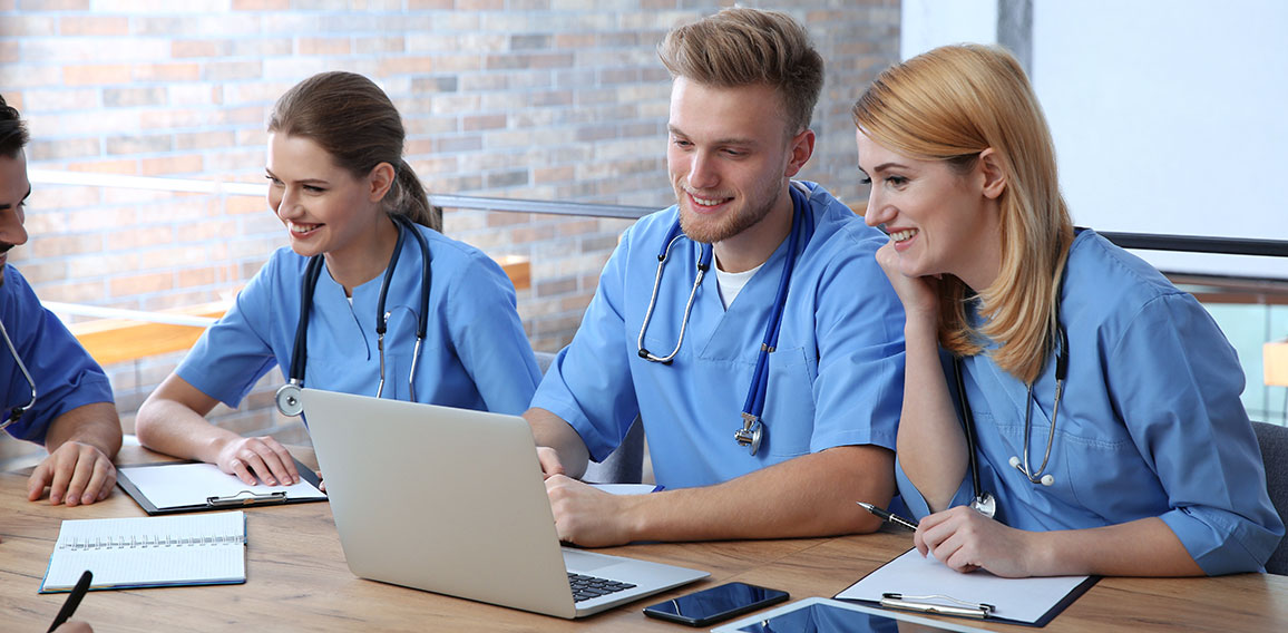 Medical students in uniforms studying at university