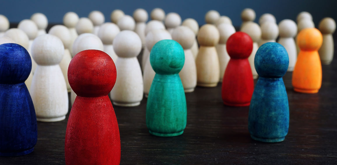 Diversity and inclusion concept. Crowd of wooden figures and color figures.