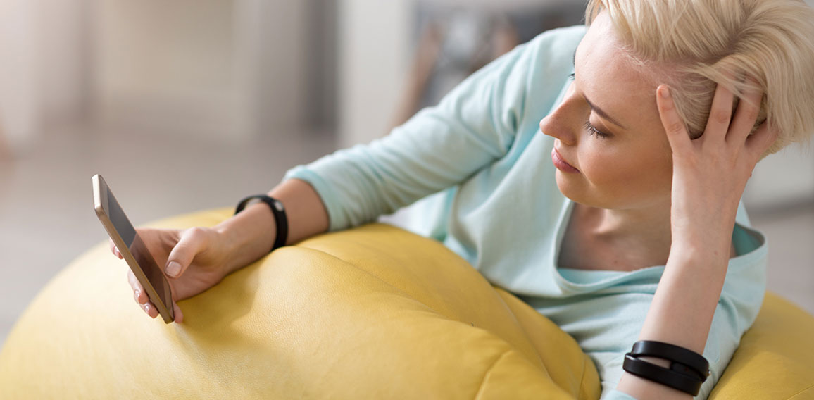 Relaxed woman using smart phone