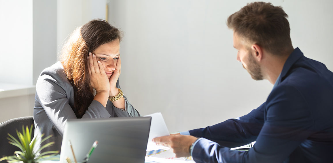 Businessman Showing Document To Female Employee