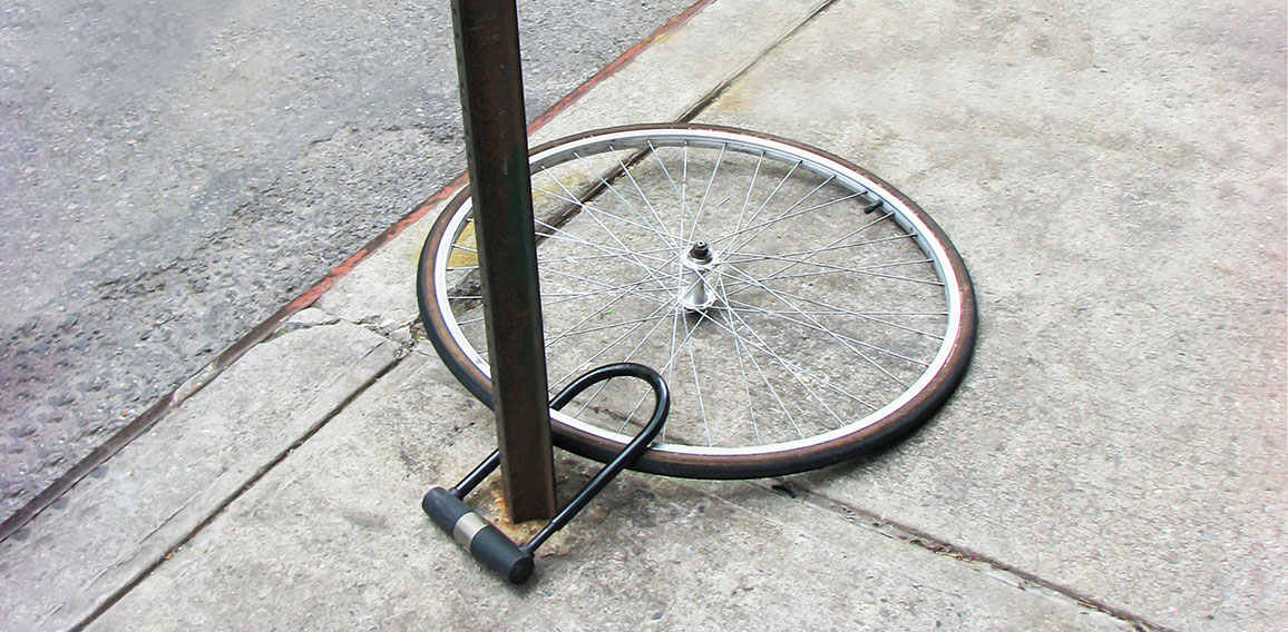 Bike wheel with padlock. Theft of a bicycle. Bicycle stolen and left only wheel.