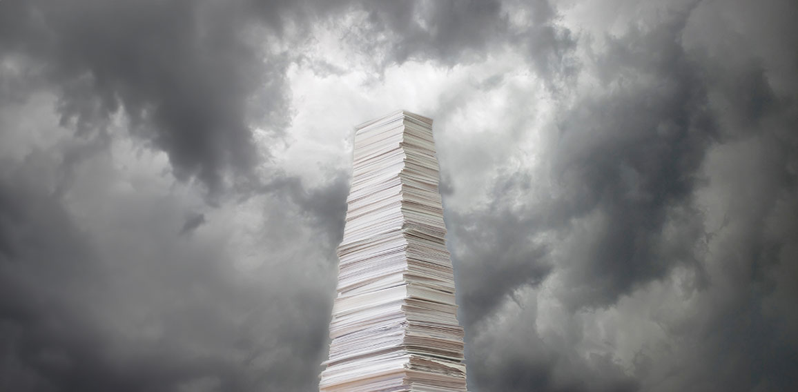 Stack of paper against a stormy sky