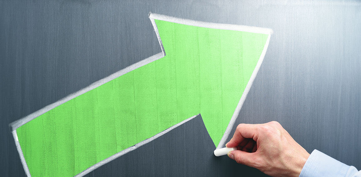 Businessman drawing yellow arrow on chalkboard. Business growth