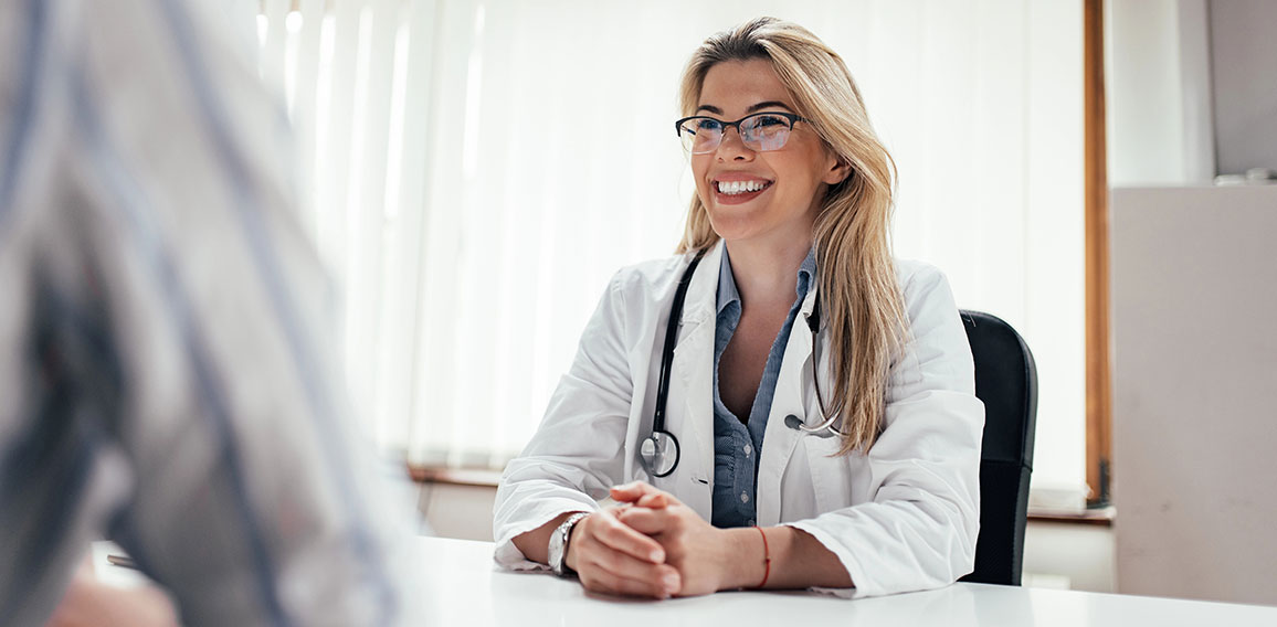 Smiling female doctor with a patient in the office.