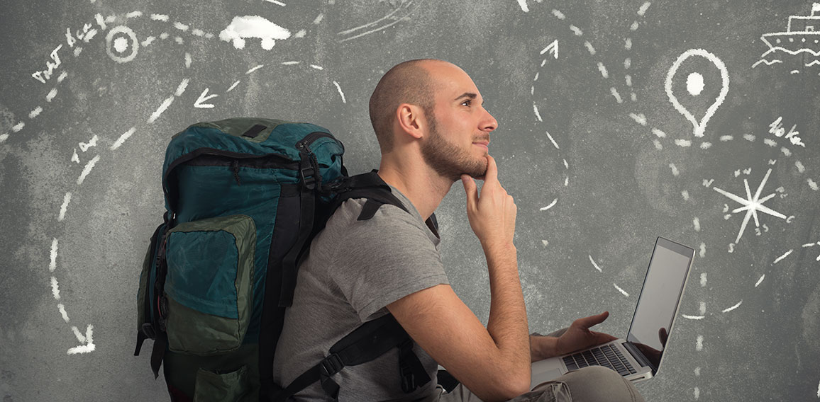 Explorer plans a new travel with his laptop