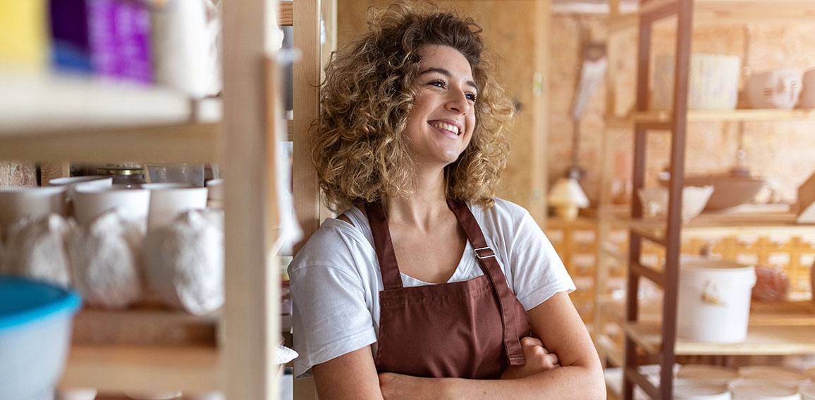 Portrait of woman pottery artist in art studio