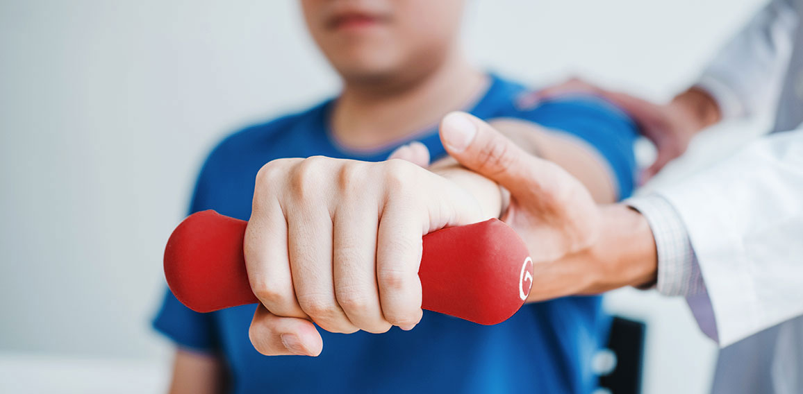 Physiotherapist man giving exercise with dumbbell treatment Abou