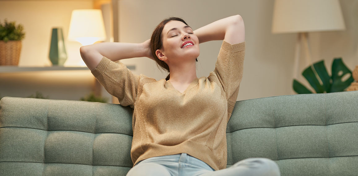 woman resting on sofa