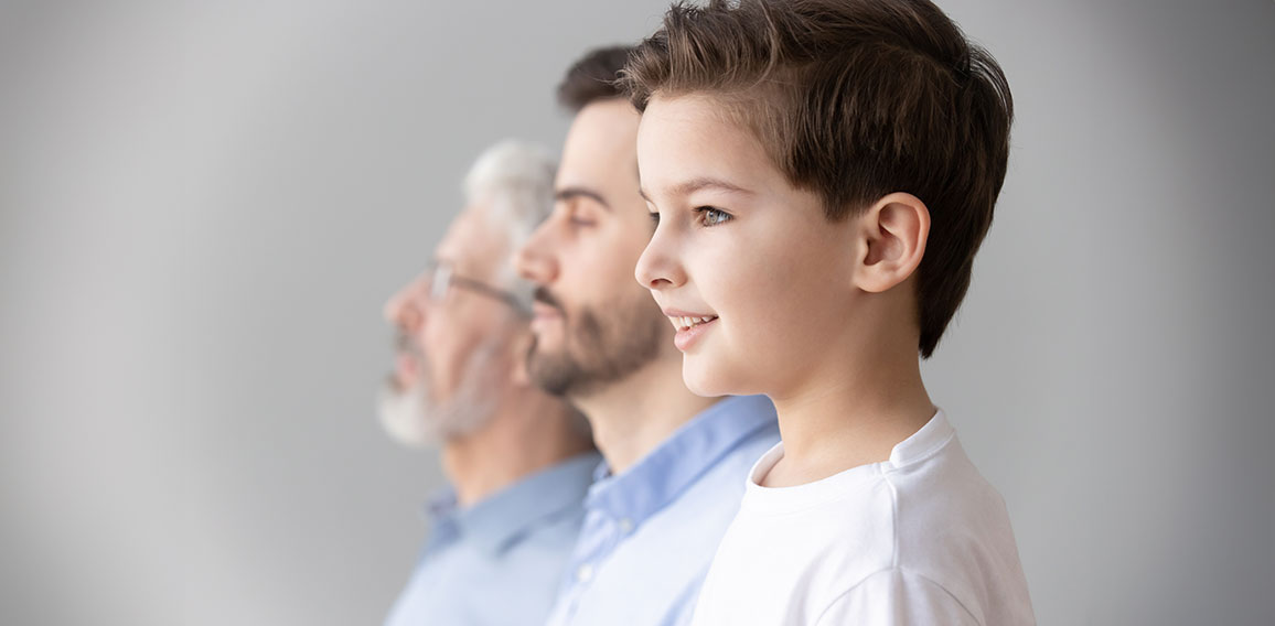 Child boy grandson stand in row with father and grandfather