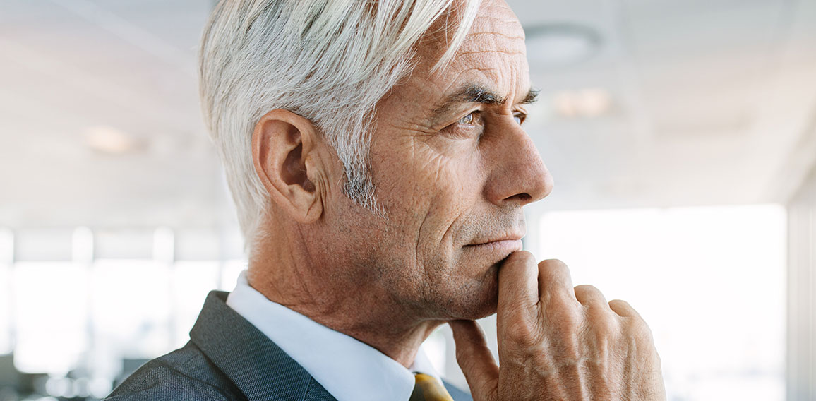 Senior entrepreneur looking pensive in office