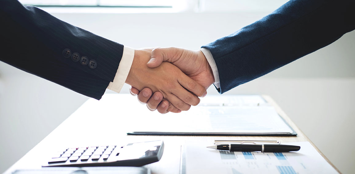 Finishing up a meeting, handshake of two happy business people a