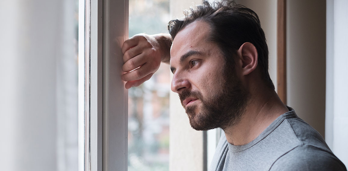 Man suffering and feeling alone at home