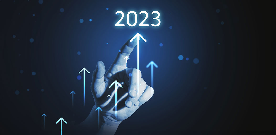 Hand touching year 2023 hologram over blue background. Business and technology concept