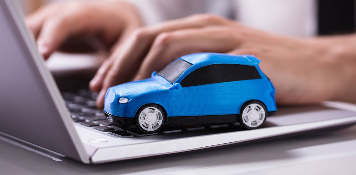 Blue Car On Laptop Keypad