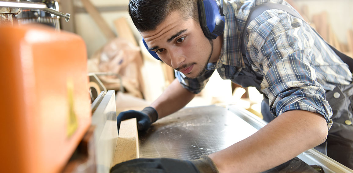 Young man in woodwork training course