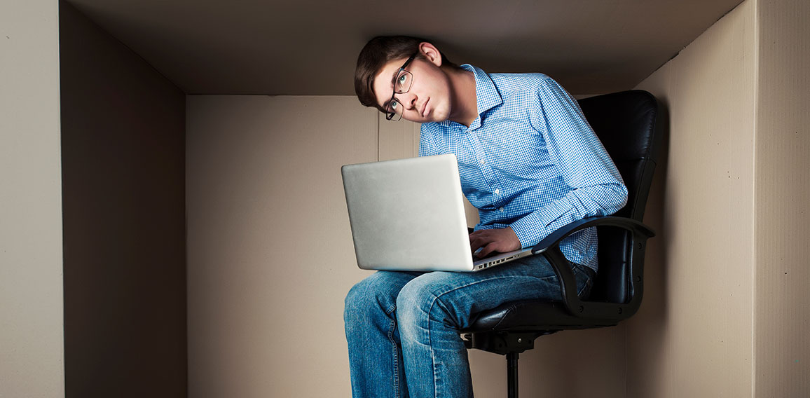 teenager, student in small office working on laptop, in an uncom