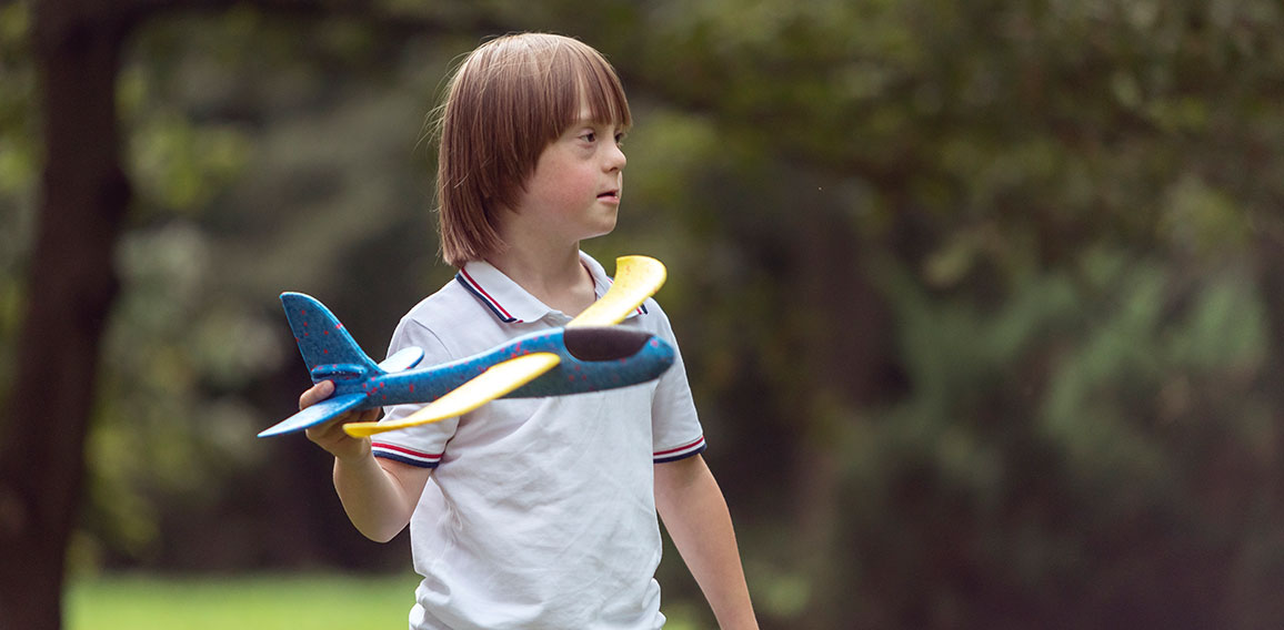 Mentally Challenged Boy Launching a Toy Airplane