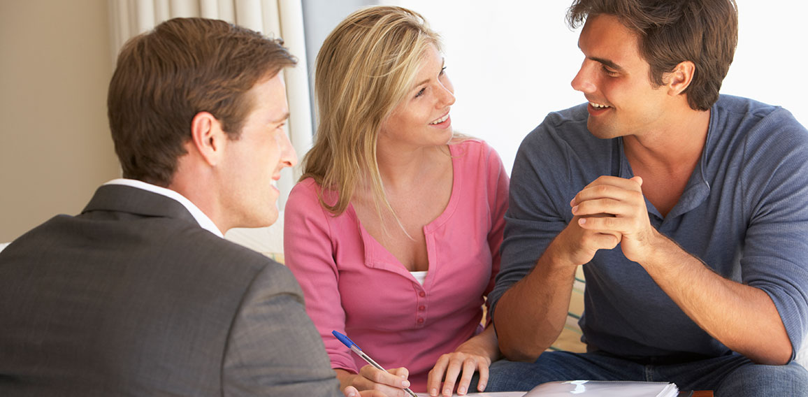 Couple Meeting With Financial Advisor At Home