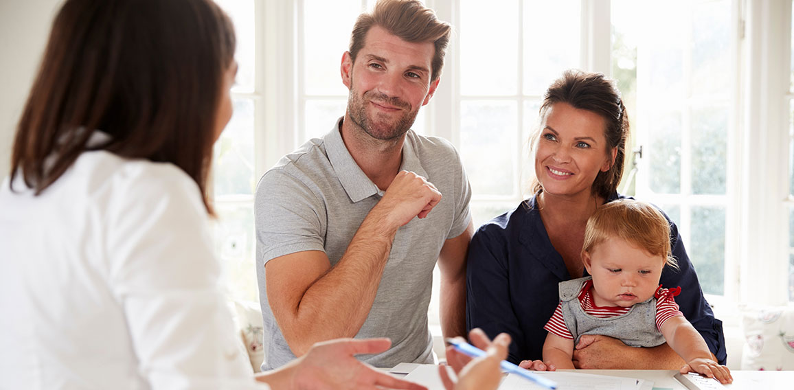 Family With Baby Meeting Financial Advisor At Home