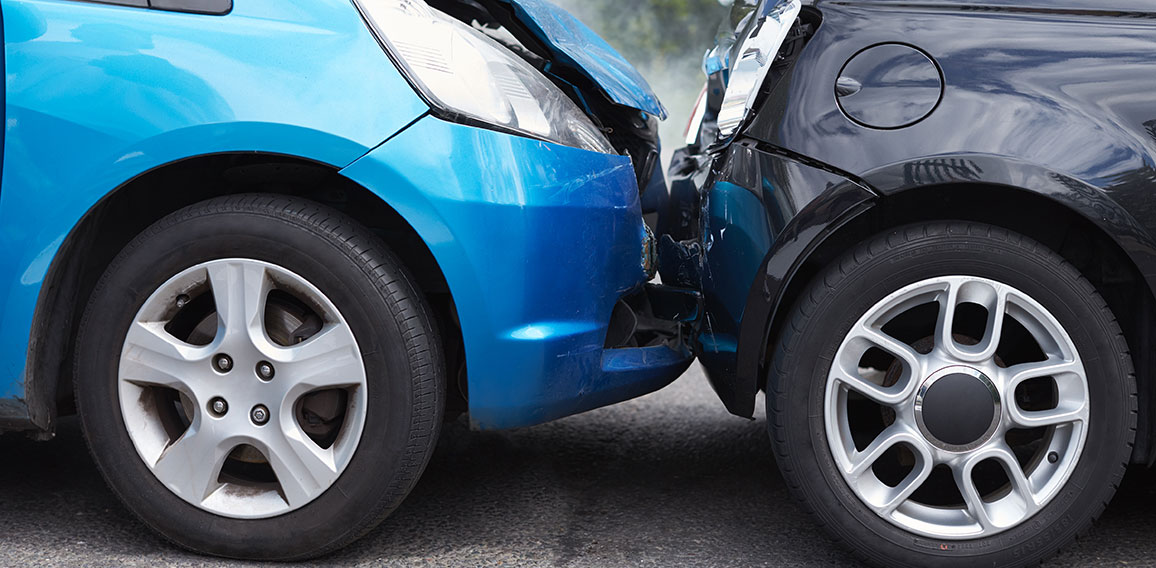 Close Up Of Two Cars Damaged In Road Traffic Accident