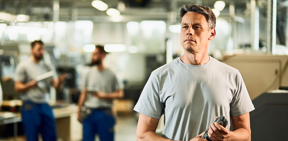 Portrait of industrial facility engineer at production line.