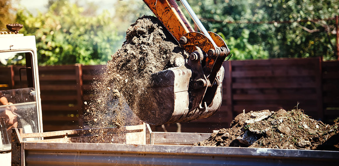 industrial backhoe excavator moving earth on construction site