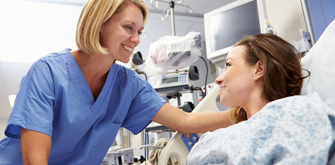 Young Female Patient Talking To Nurse In Emergency Room