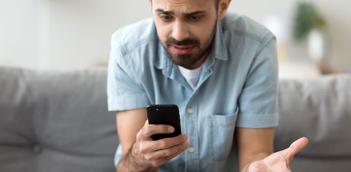 Close up confused man having problem with phone, receive bad news