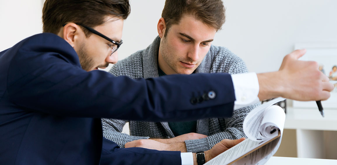 Business young man explaining terms of contract to his client in