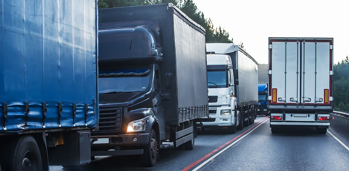 Trucks in a traffic jam on a suburban highway.