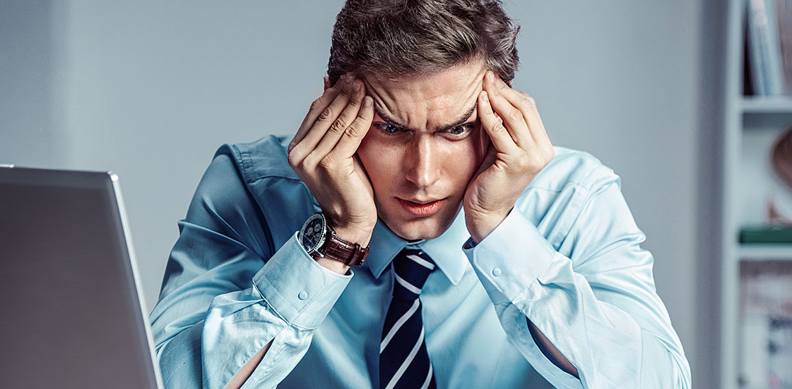 Young worker sitting in his office thinking. Business concept